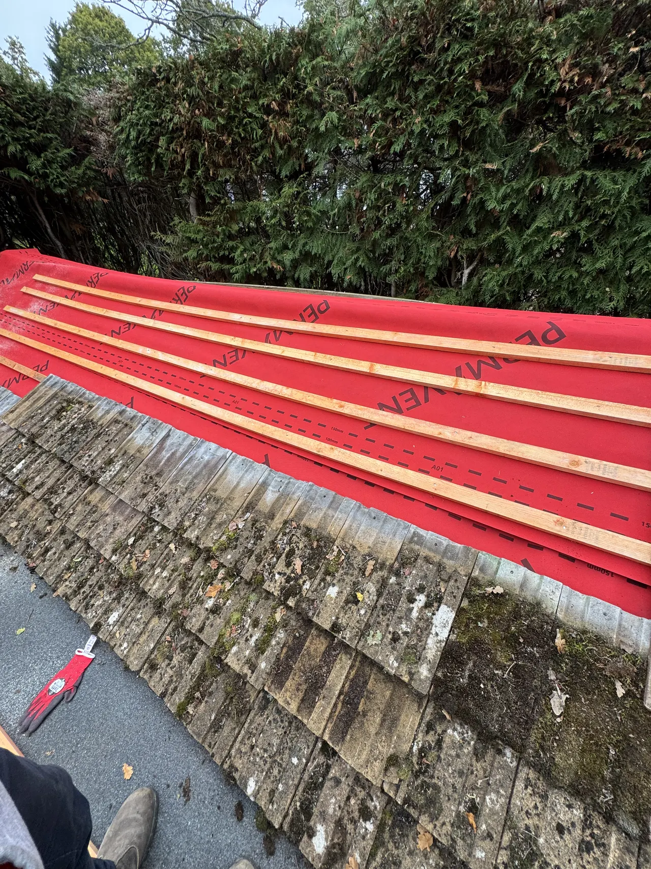 New membrane and battens meeting old concrete tiles on the same roof