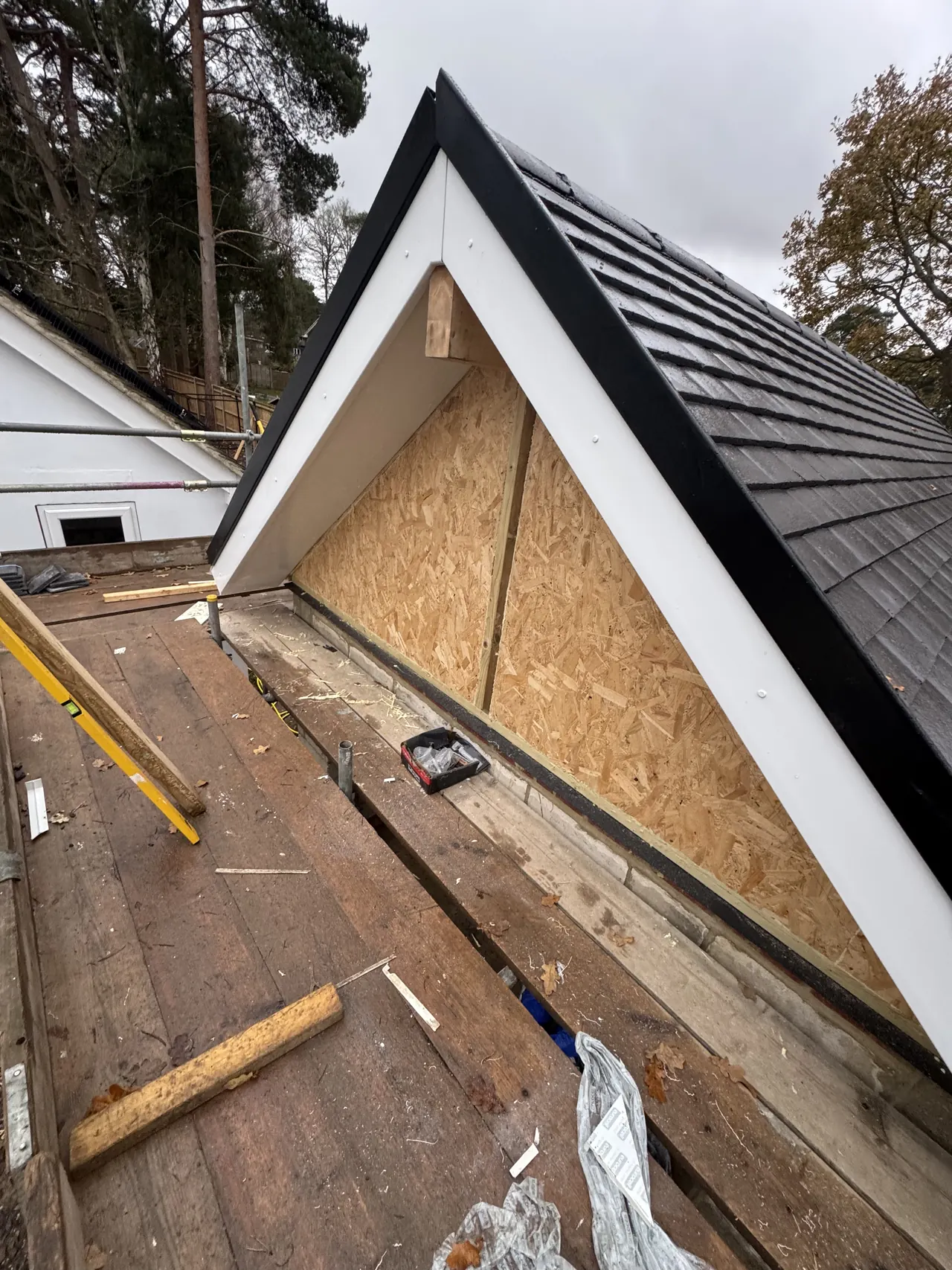 Gable end of the new roof with OSB boarding, white fascia and soffit